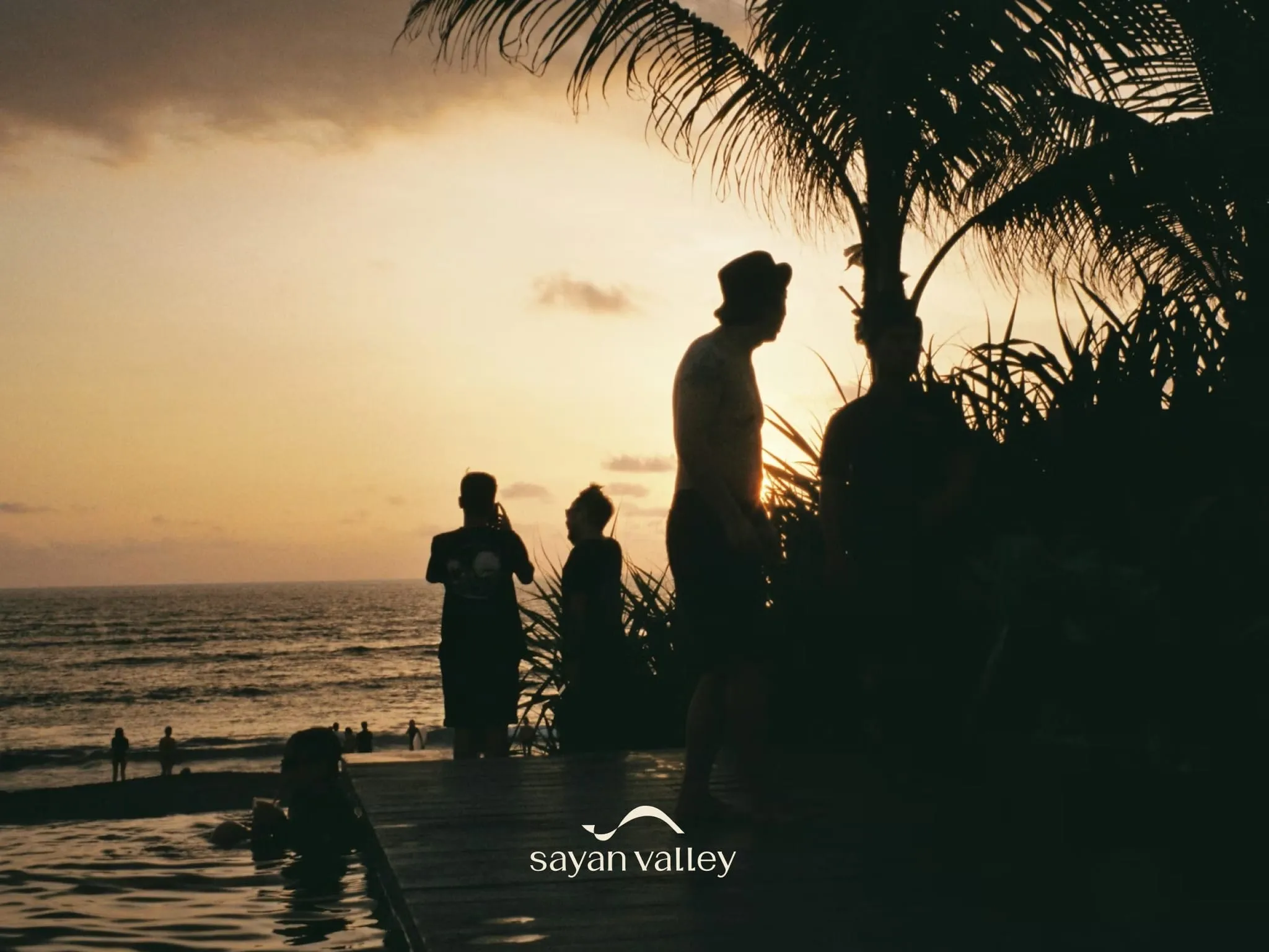 cocktail-party-at-bali Silhouette of a waiter serving drinks at a beach club during the peak bali sunset time.