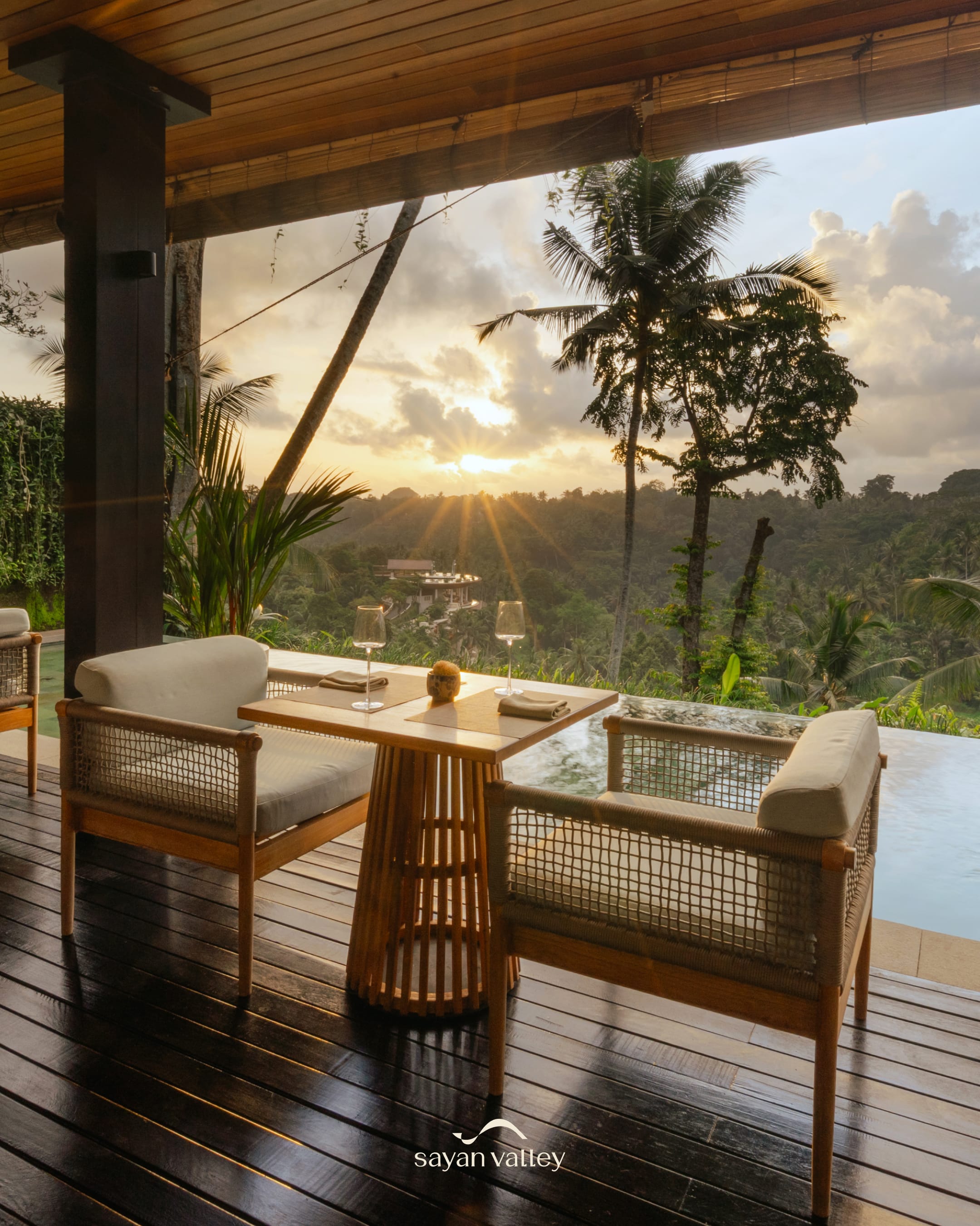 legant table setup at Sayan Valley overlooking the forest during the iconic bali sunset time.