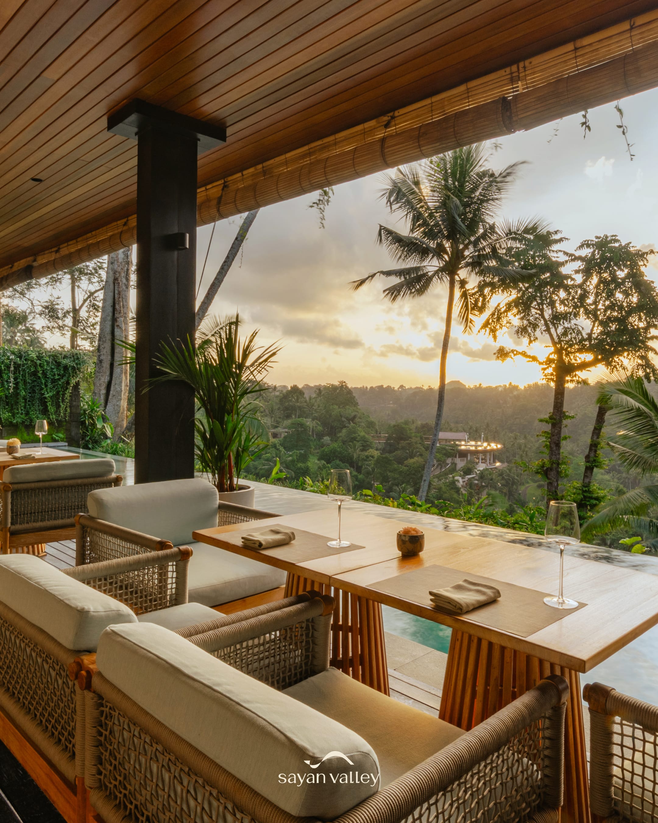 Luxury dining terrace in Ubud with a stunning view of the valley at sunset time in bali.
