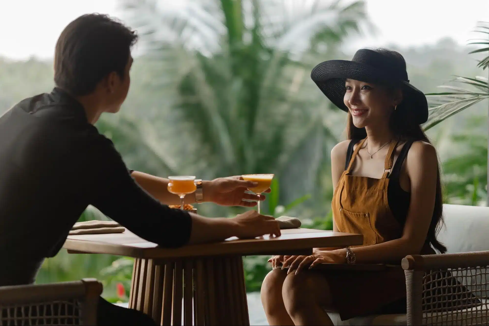 Silhouette of a waiter serving drinks at a beach club during the peak bali sunset time.