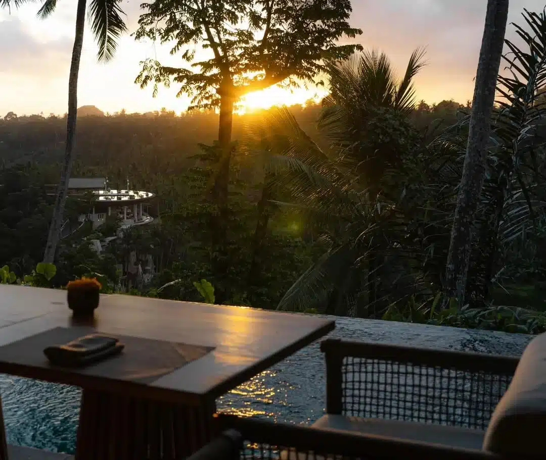 Silhouette of a waiter serving drinks at a beach club during the peak bali sunset time.