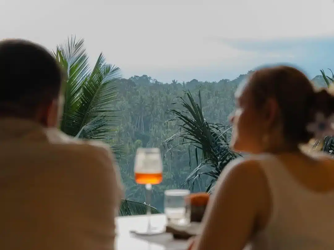 Silhouette of a waiter serving drinks at a beach club during the peak bali sunset time.